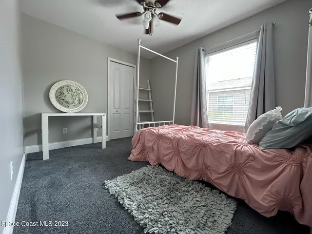 a bed sitting in a bedroom next to a window