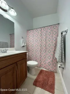 a bathroom with a toilet a sink and a shower
