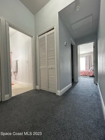 a view of a room with an empty space and wooden floor