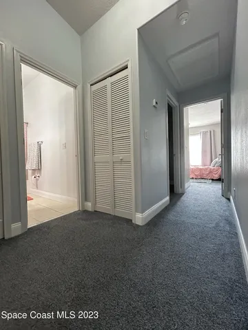 a view of a room with an empty space and wooden floor