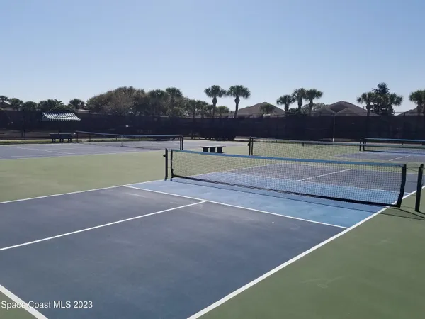 a view of a wrought iron fences in front of buildings