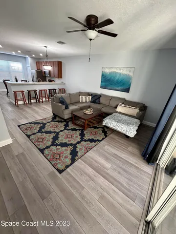 a living room with lots of furniture and kitchen view
