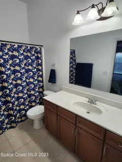 a bathroom with a sink toilet and a mirror