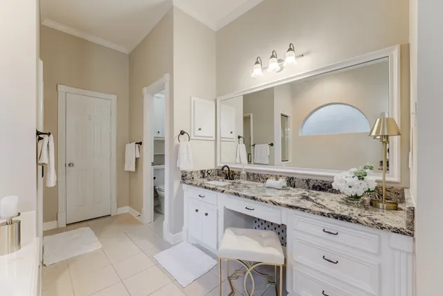 a bathroom with a granite countertop sink a mirror and a shower
