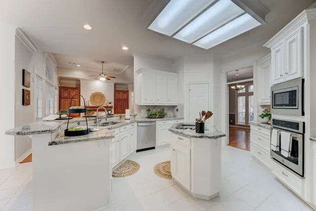 a kitchen with sink cabinets and stainless steel appliances