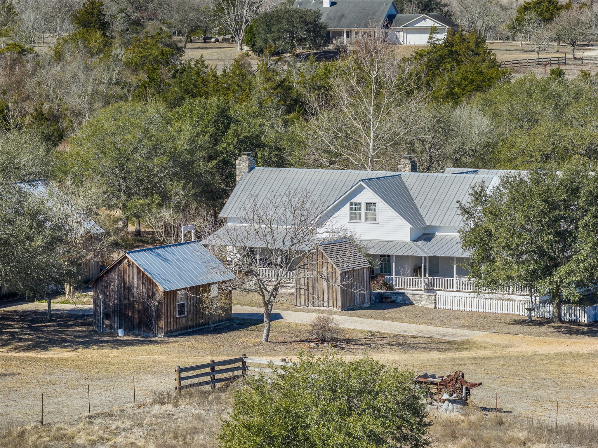an aerial view of a house with swimming pool and furniture