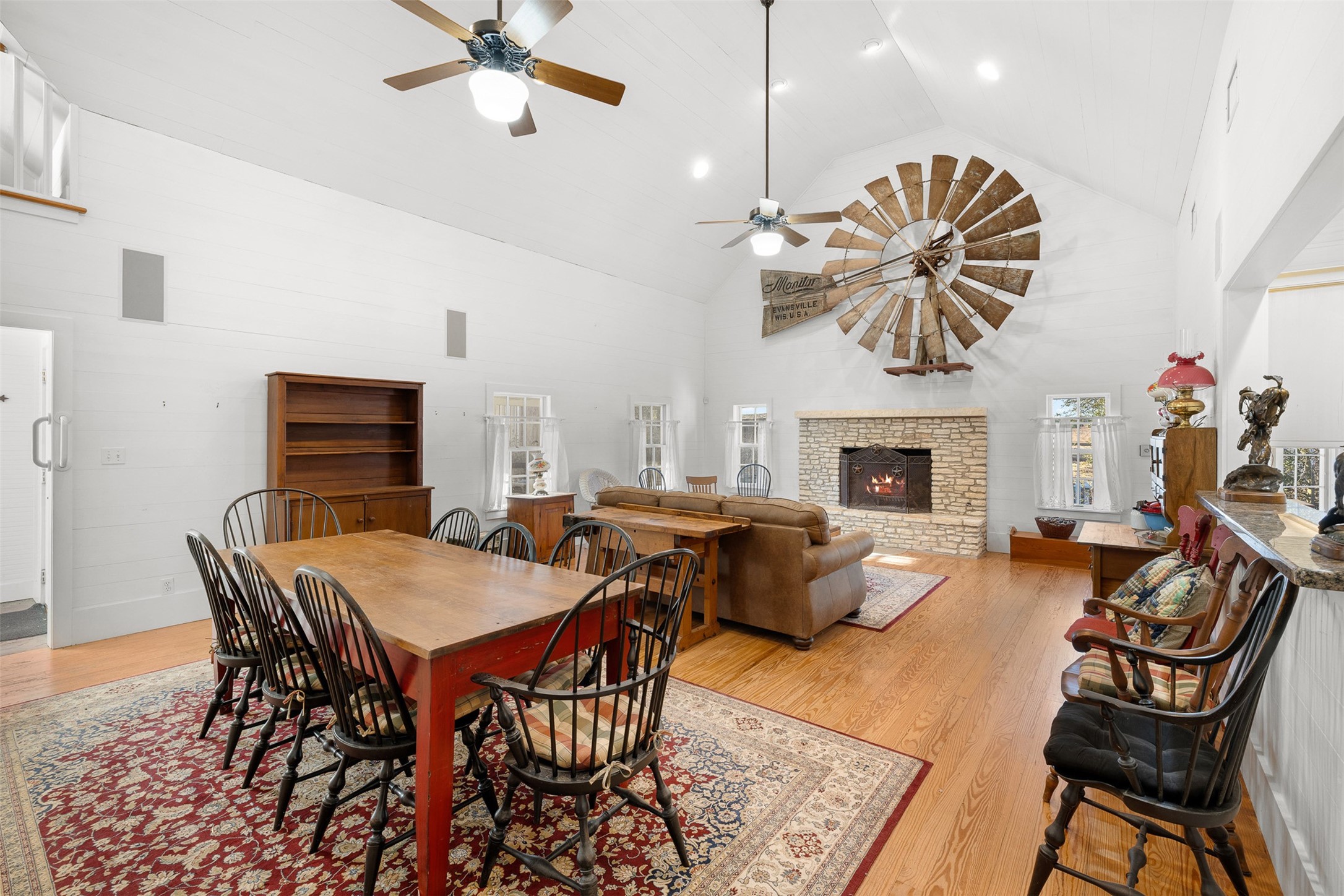 2998 Highway 237 Round Top, TX 78954 - Photo 15 of 43 a dining room with furniture a fireplace and wooden floor