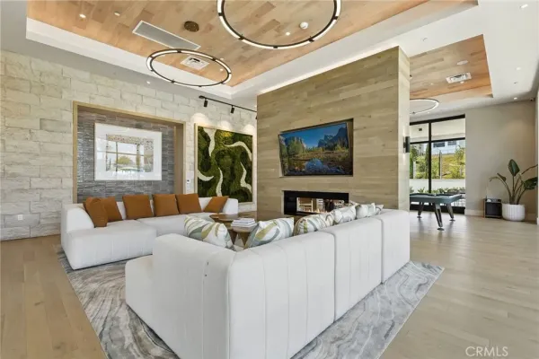 a living room with furniture a flat screen tv and a large window
