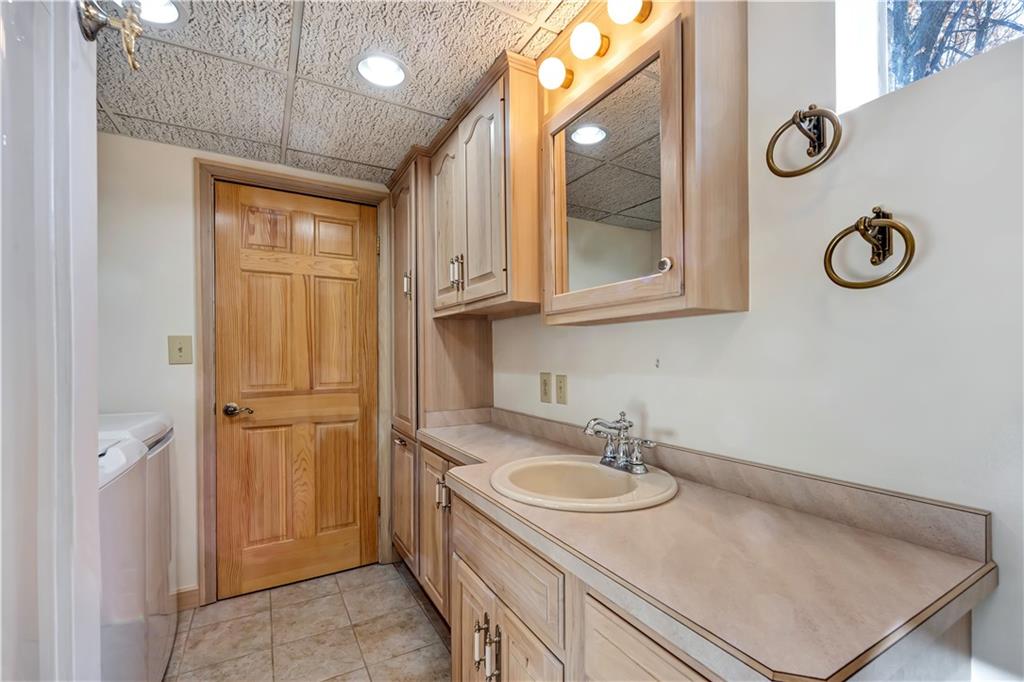 18 Colwell Street Burgettstown, PA 15021 - Photo 29 of 39 a bathroom with a sink a vanity and a mirror