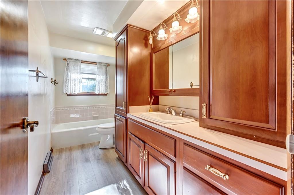 18 Colwell Street Burgettstown, PA 15021 - Photo 7 of 39 a bathroom with a sink a large mirror and a bathtub