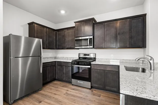 a kitchen with a refrigerator sink and microwave