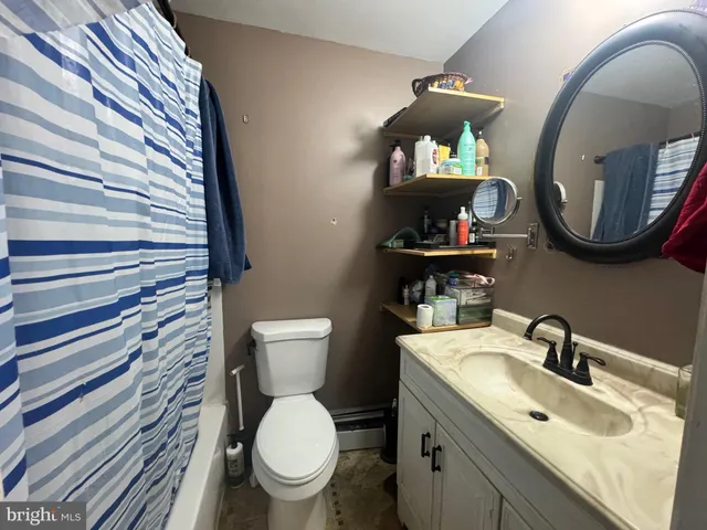 a bathroom with a toilet a sink and a mirror