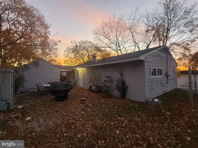 a backyard of a house with yard and outdoor seating