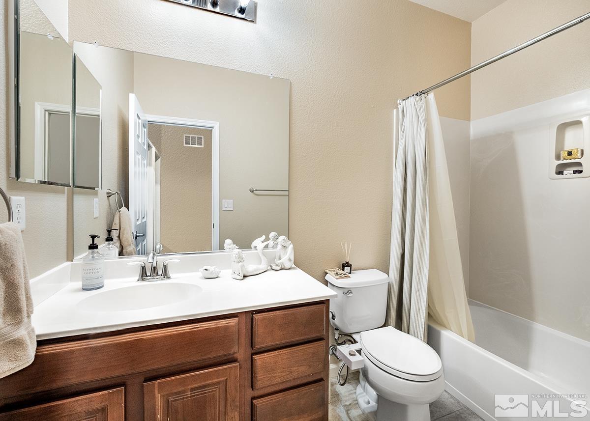 1865 Wind Ranch Road, Unit B Reno, NV 89521 - Photo 15 of 26 a bathroom with a sink toilet and shower