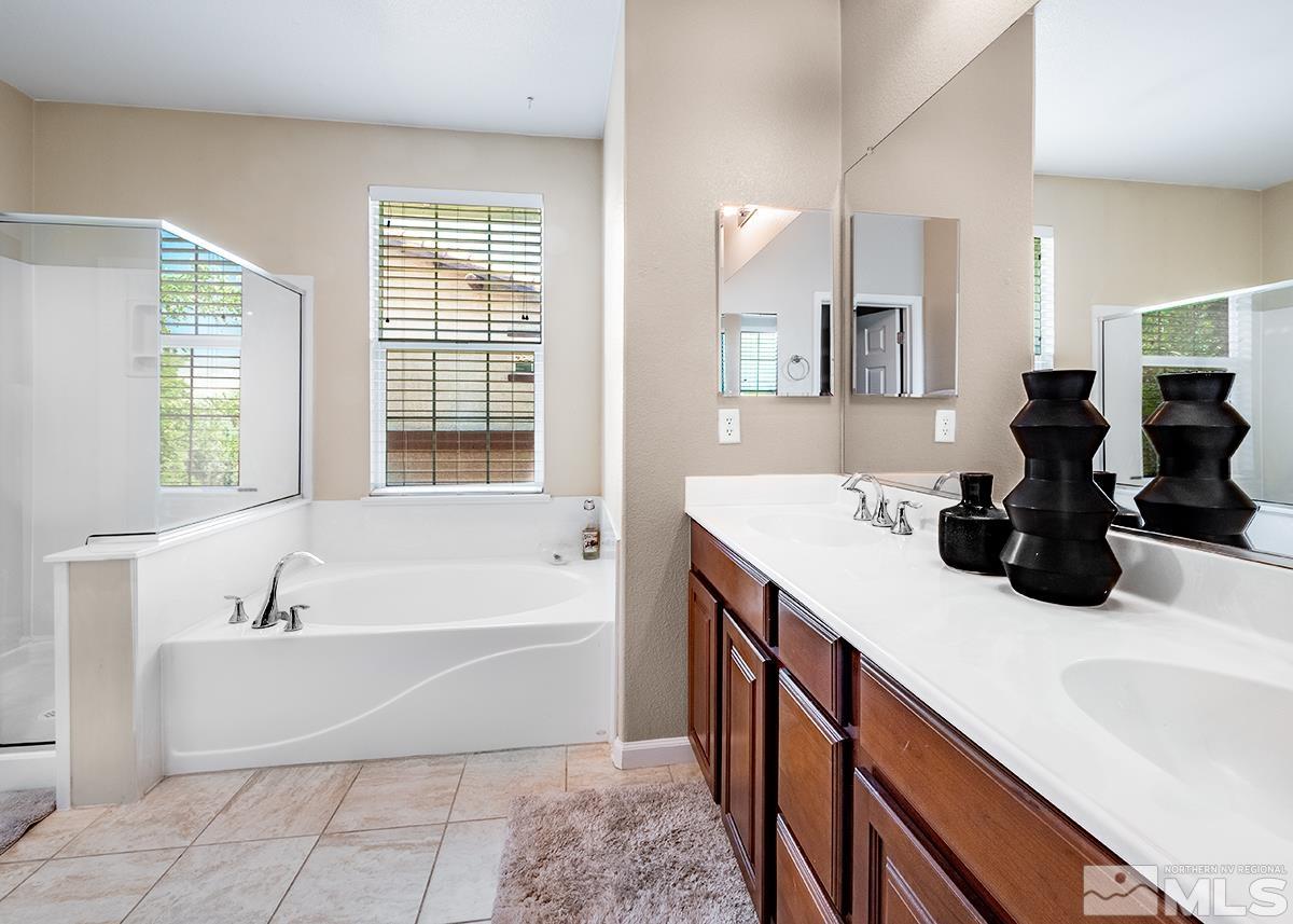1865 Wind Ranch Road, Unit B Reno, NV 89521 - Photo 20 of 26 a bathroom with a large tub sink and vanity