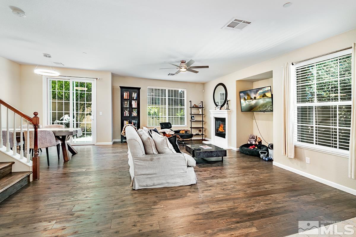 1865 Wind Ranch Road, Unit B Reno, NV 89521 - Photo 3 of 26 a living room with fireplace furniture and a large window