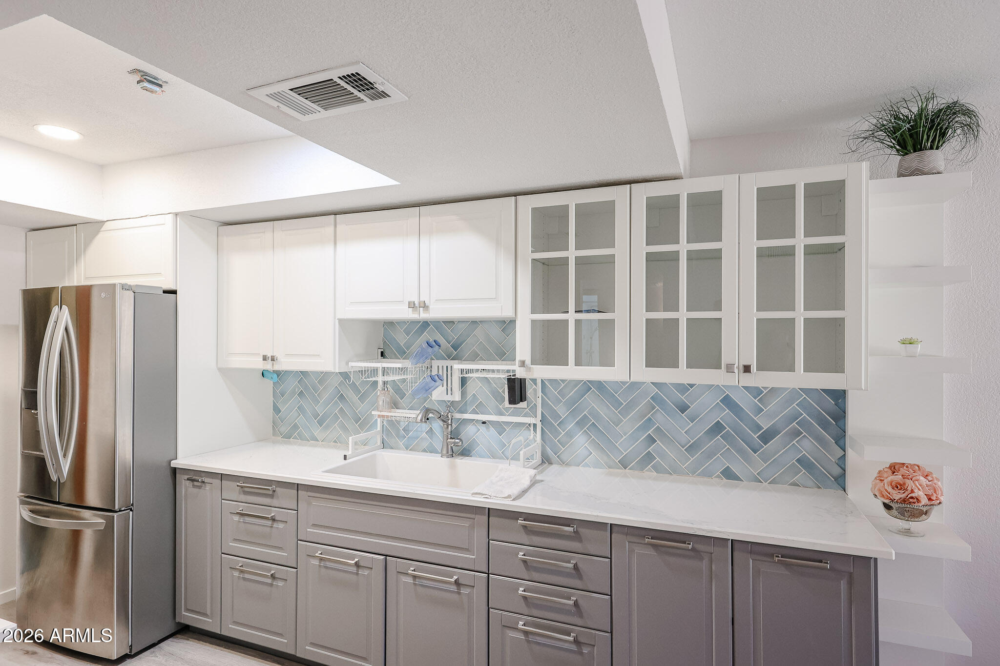 5114 East Monte Vista Road Phoenix, AZ 85008 - Photo 6 of 45 a kitchen with a refrigerator and cabinets