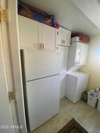 a white refrigerator freezer sitting next to a white cabinet
