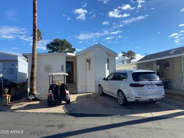 a white car parked in front of a house