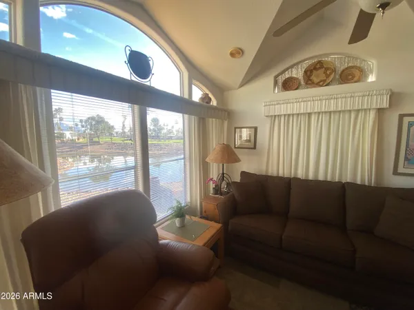 a living room with furniture and a floor to ceiling window