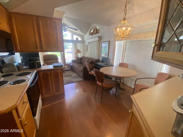 a view of a dining room with furniture and chandelier