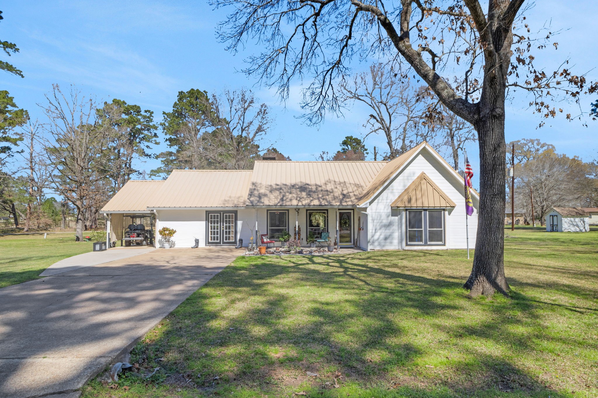 a front view of a house with a yard and trees