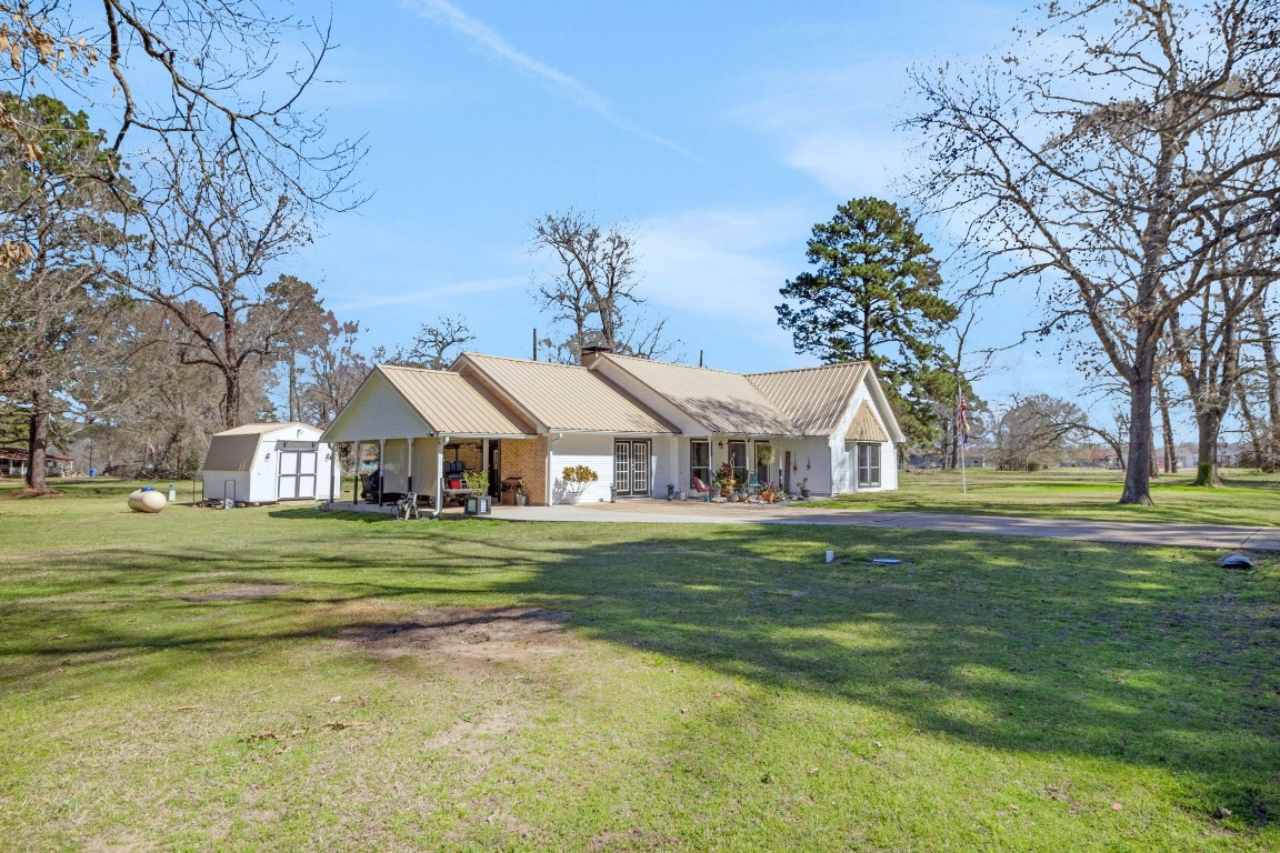 144 Thornton Road Trinity, TX 75862 - Photo 7 of 39 a front view of a house with a garden