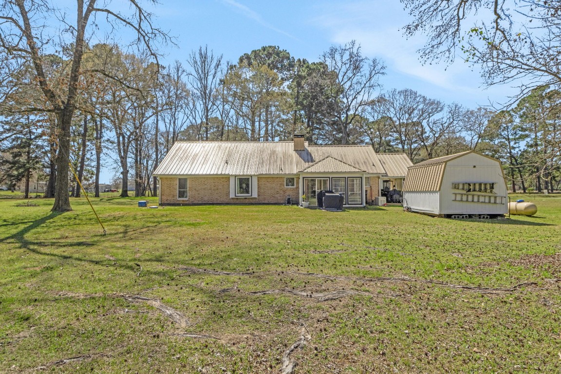144 Thornton Road Trinity, TX 75862 - Photo 8 of 39 a front view of house with yard and garage