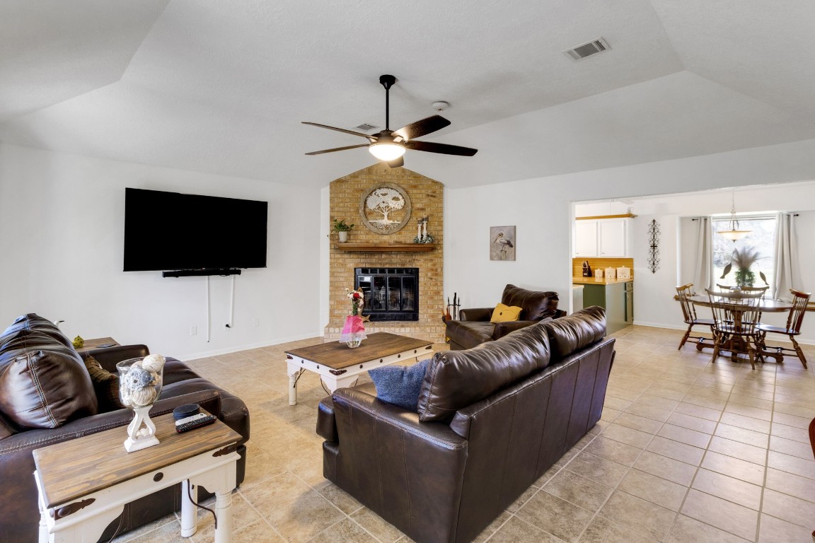 144 Thornton Road Trinity, TX 75862 - Photo 9 of 39 a living room with furniture a flat screen tv and a fireplace