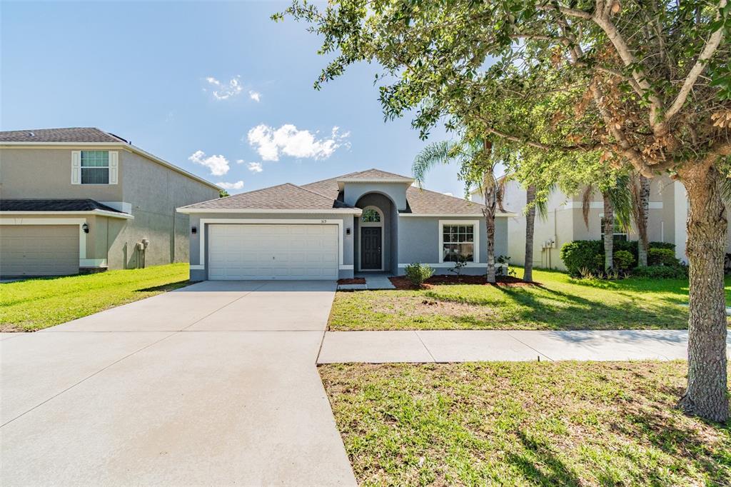 315 Shell Manor Drive Ruskin, FL 33570 - Photo 1 of 1 a front view of a house with a yard and garage