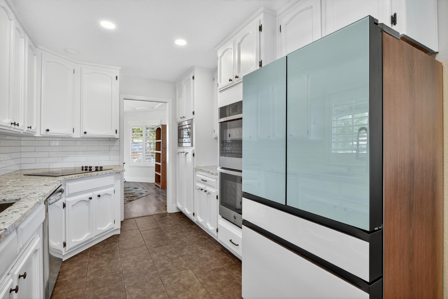 2325 Rio Verde Drive Riverbank, CA 95367 - Photo 13 of 43 a kitchen with stainless steel appliances granite countertop a refrigerator and a stove