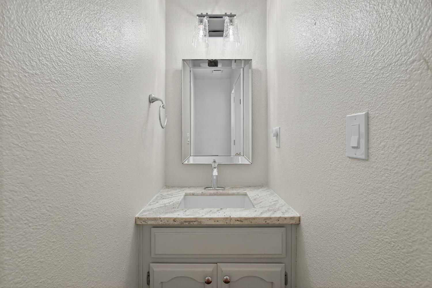 2325 Rio Verde Drive Riverbank, CA 95367 - Photo 19 of 43 a bathroom with a granite countertop sink and a mirror