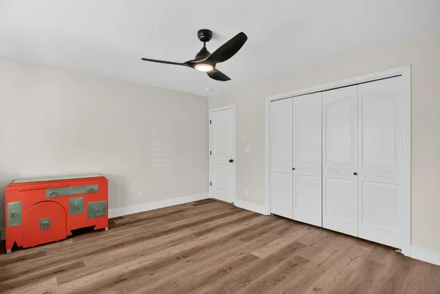a view of room with hardwood floor and ceiling fan