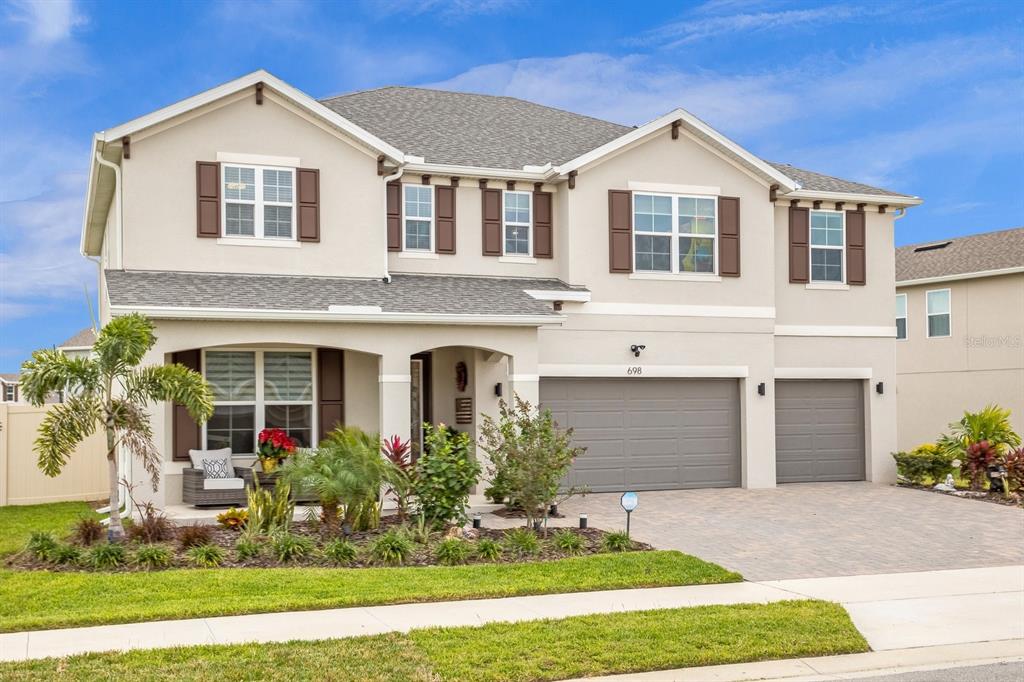 698 Sadie Ridge Road Minneola, FL 34715 - Photo 1 of 1 a front view of a house with a yard and garage