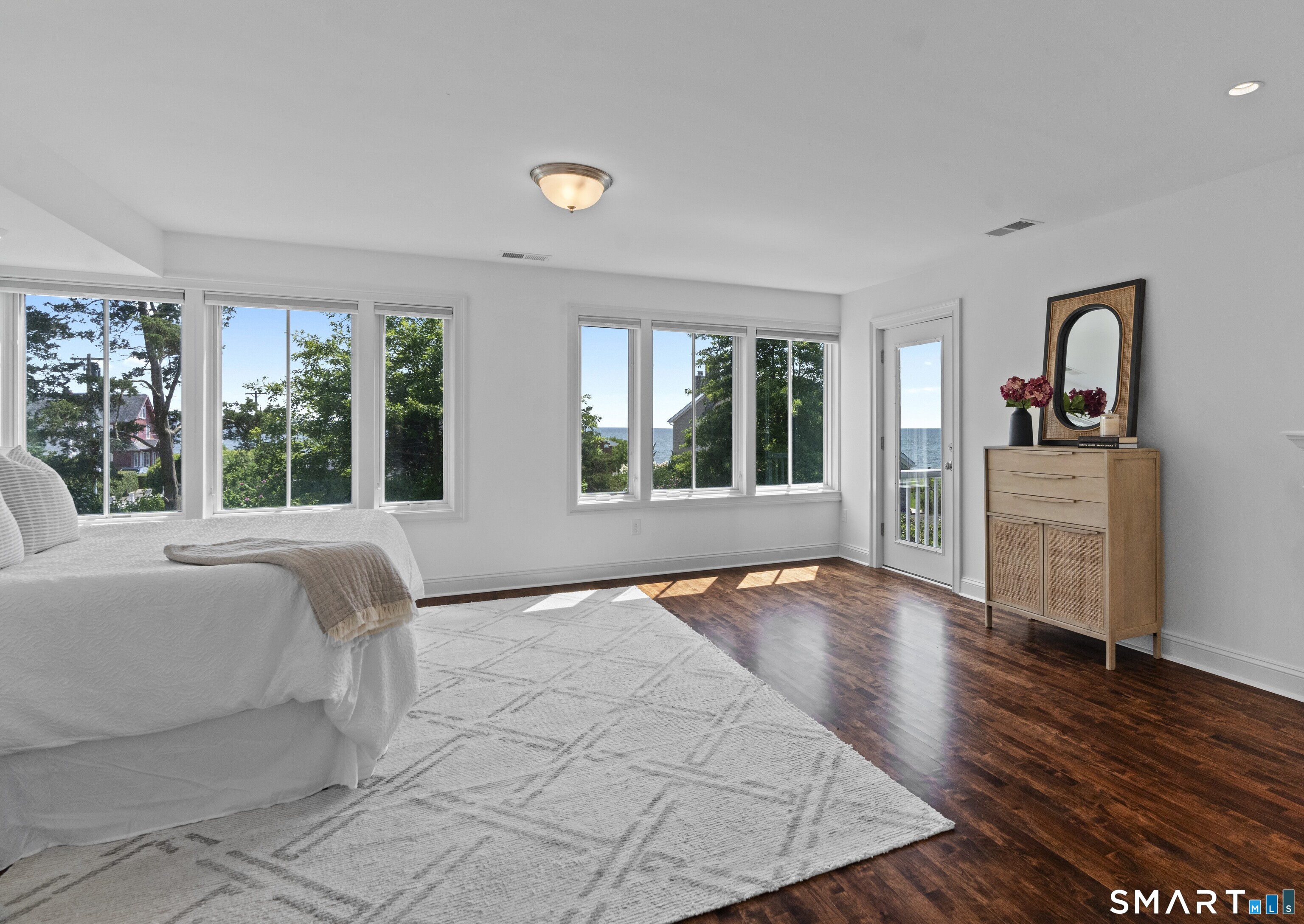 64 Webster Point Road Madison, CT 06443 - Photo 21 of 36 a view of a bedroom with wooden floor and a window