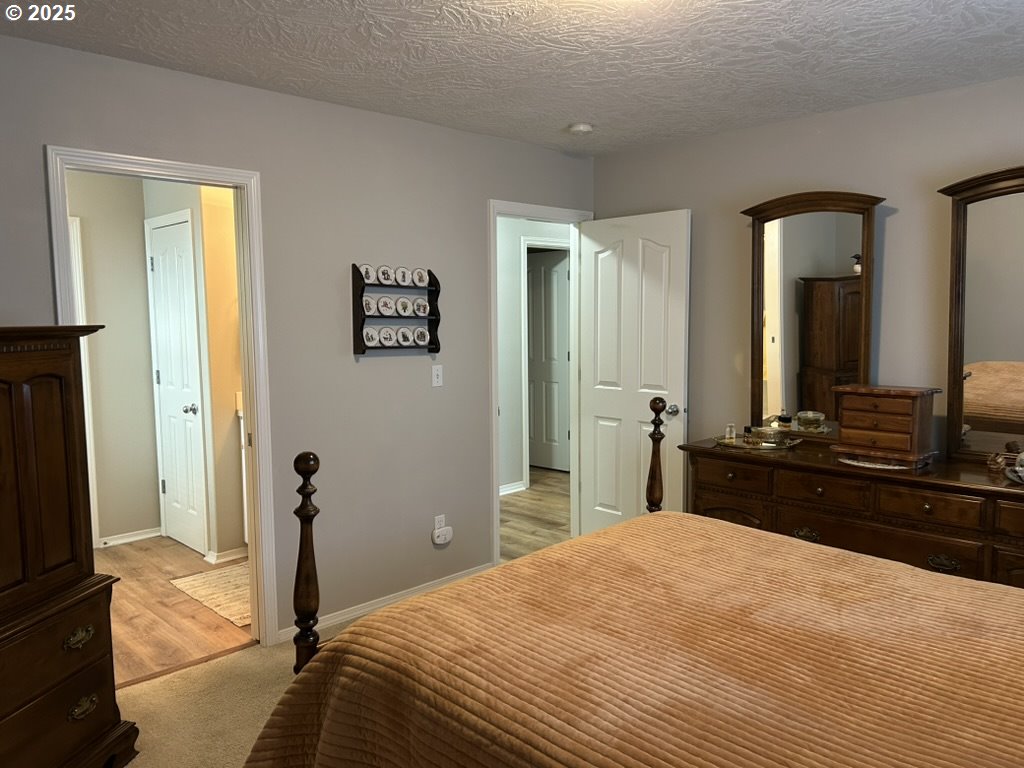 736 Kelsey Loop Molalla, OR 97038 - Photo 12 of 21 a bedroom with a bed and a flat tv screen on dresser
