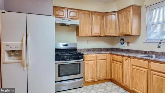 a kitchen with granite countertop cabinets and window