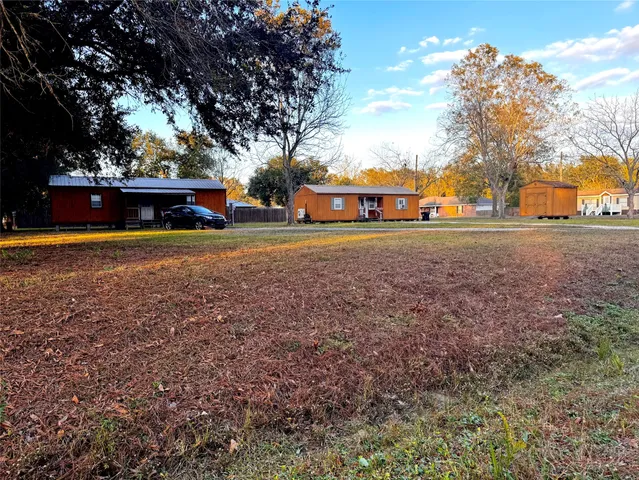 a front view of house with yard and trees