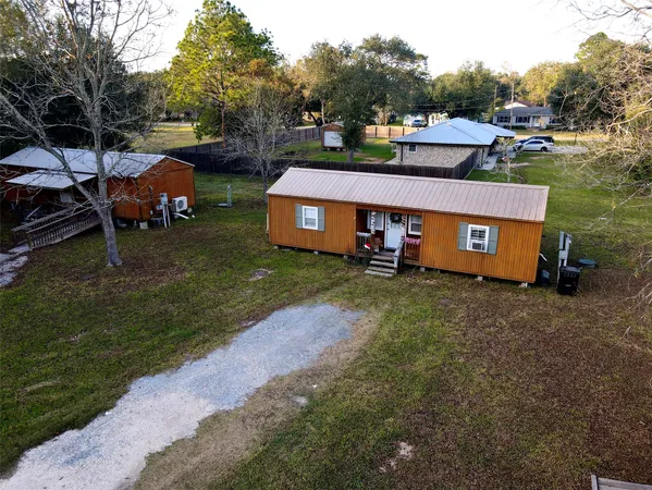 an aerial view of a house with garden space and street view