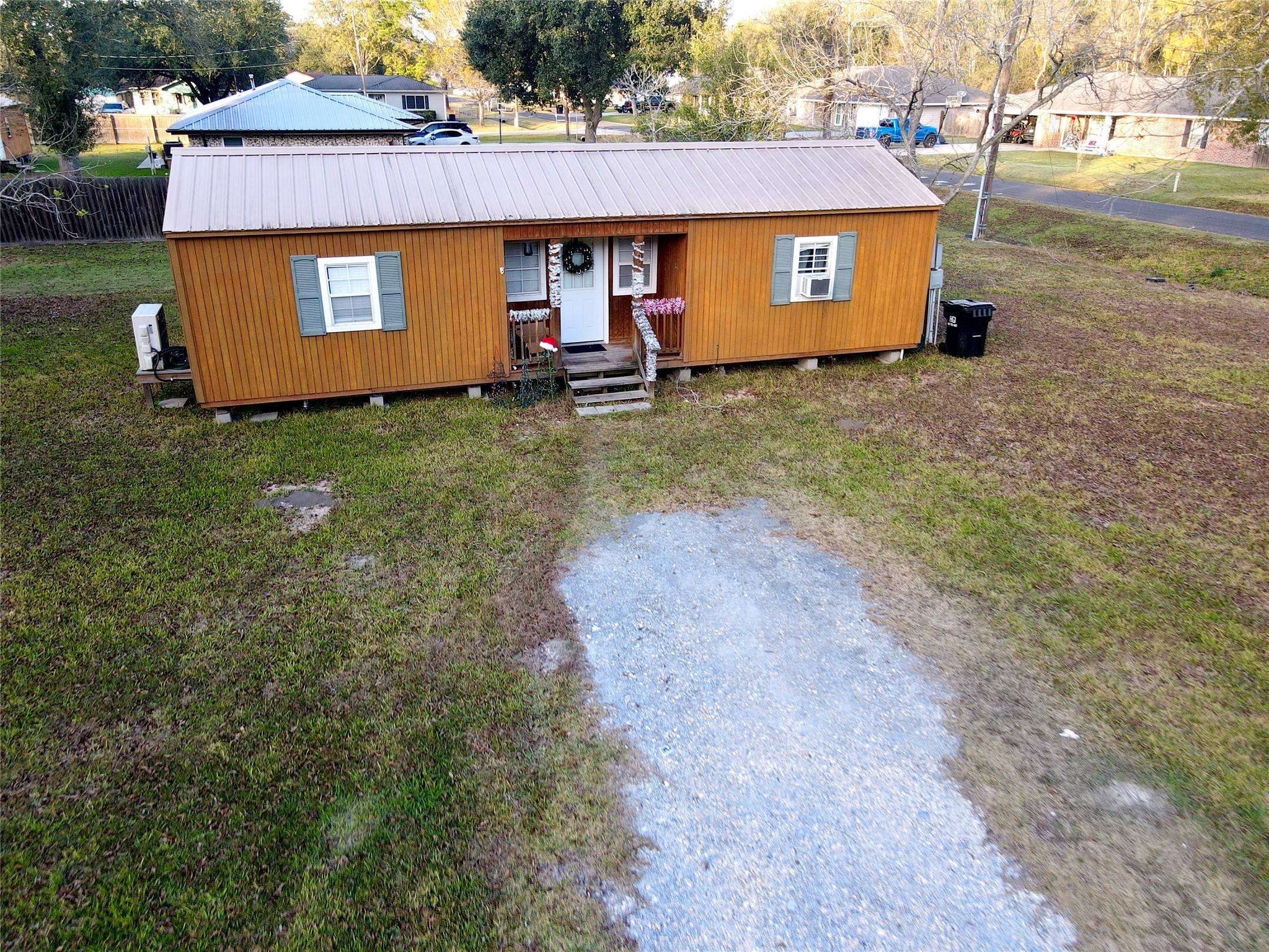 369 East Chestnut Avenue Winnie, TX 77665 - Photo 5 of 20 a front view of a house with a yard