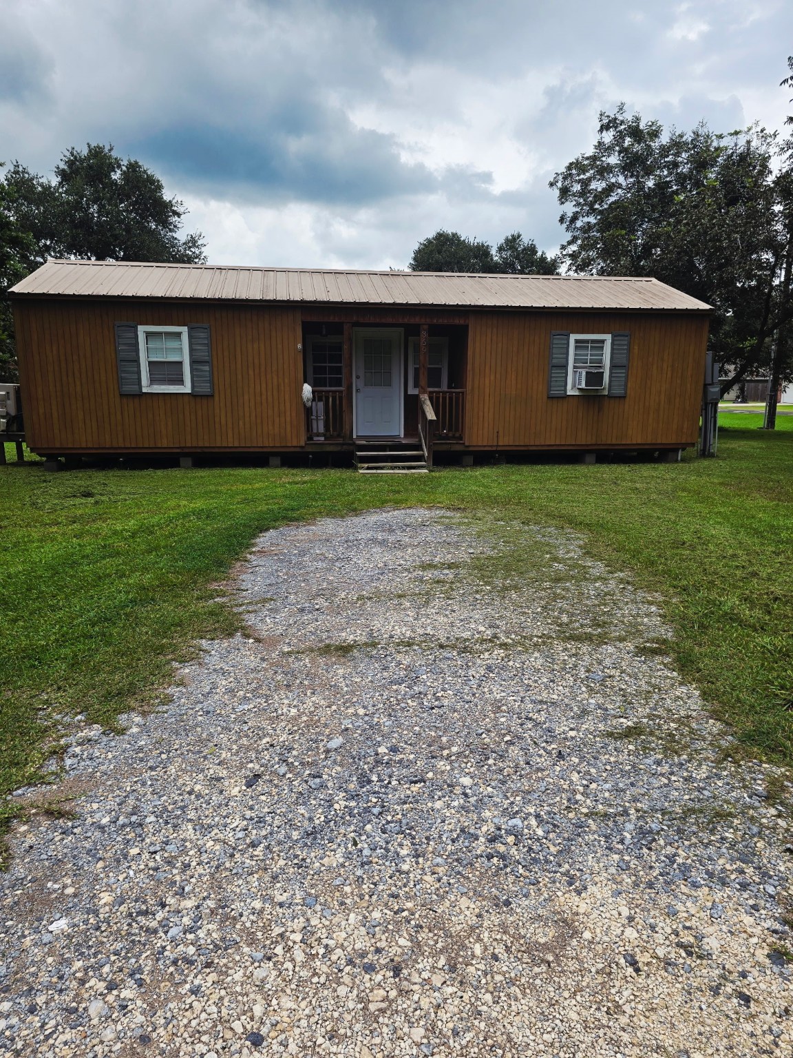 369 East Chestnut Avenue Winnie, TX 77665 - Photo 6 of 20 a front view of a house with a garden