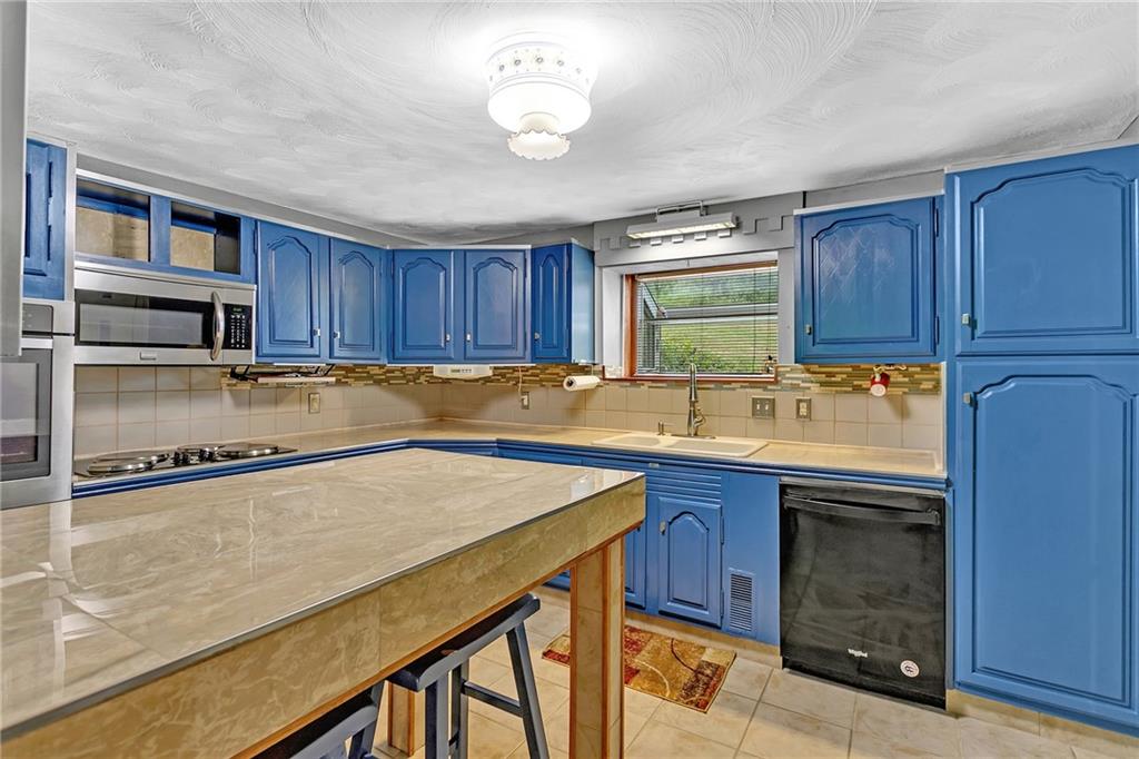 2665 Berlin Farm Road Export, PA 15632 - Photo 21 of 39 a kitchen with stainless steel appliances granite countertop wooden cabinets a sink and dishwasher