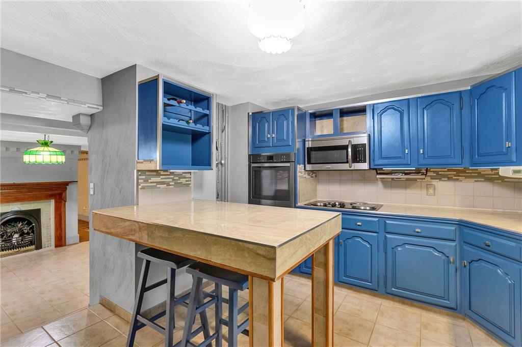 2665 Berlin Farm Road Export, PA 15632 - Photo 22 of 39 a kitchen with stainless steel appliances granite countertop a table chairs sink and cabinets