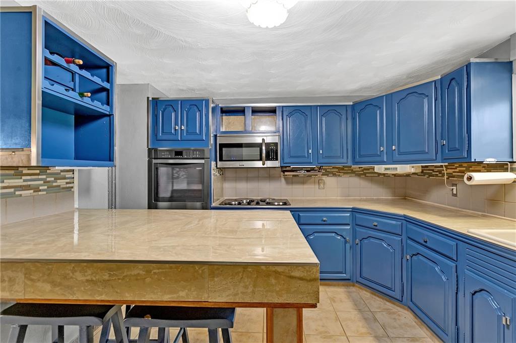 2665 Berlin Farm Road Export, PA 15632 - Photo 23 of 39 a kitchen with wooden cabinets a sink and dishwasher
