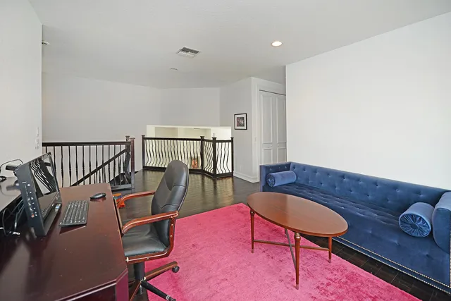 a living room with furniture rug and wooden floor