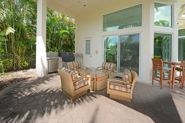 a view of backyard with outdoor seating and green space
