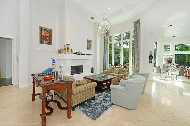 a living room with furniture chandelier and a large window