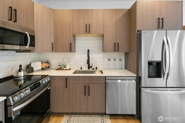 a kitchen with a sink a stove and refrigerator