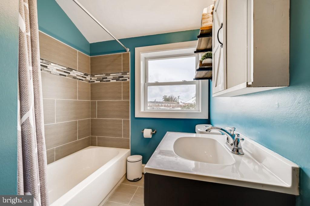 8023 Wallace Road Baltimore, MD 21222 - Photo 11 of 21 a bathroom with a sink a bathtub and a shower