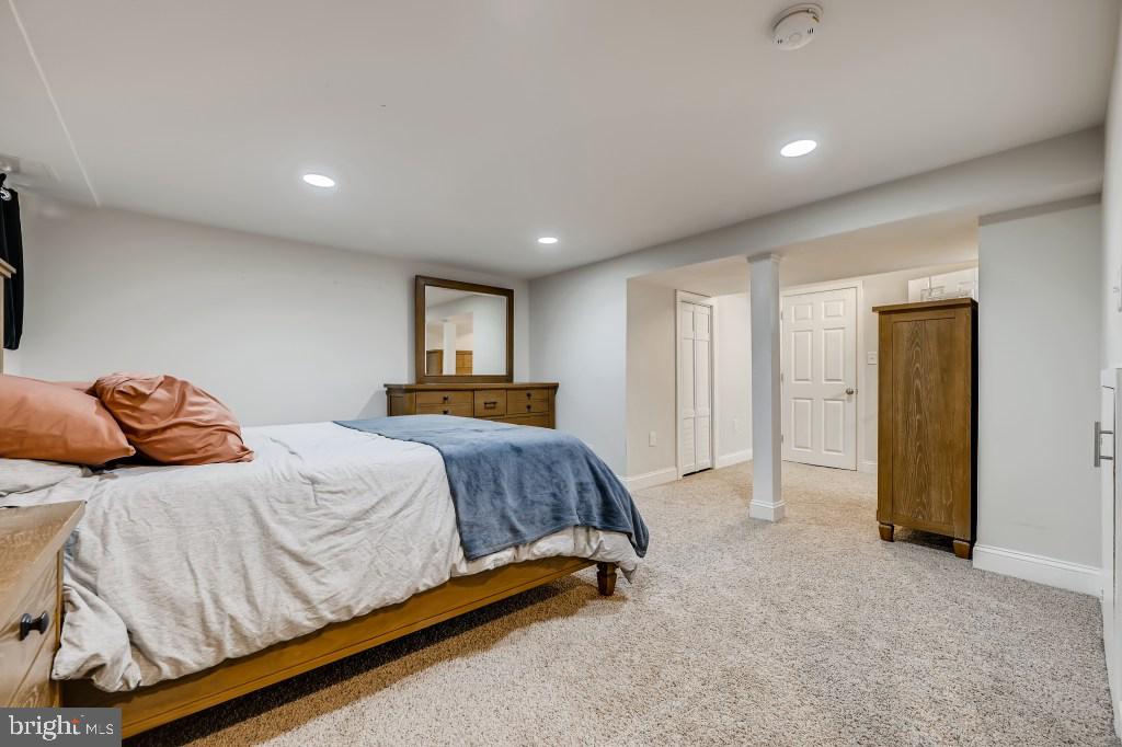 8023 Wallace Road Baltimore, MD 21222 - Photo 12 of 21 a spacious bedroom with a bed and a refrigerator